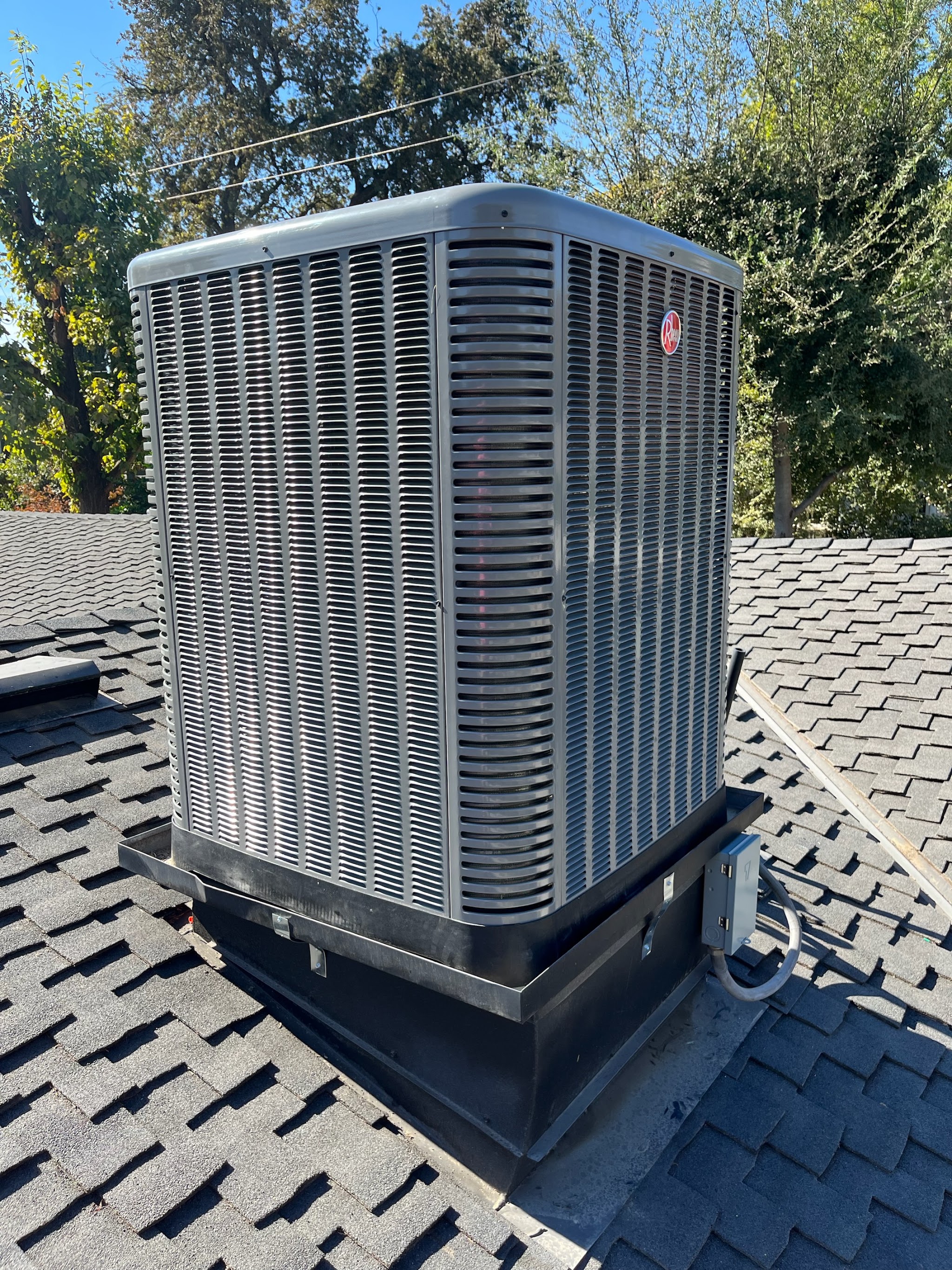 Newly installed condenser unit against a home exterior
